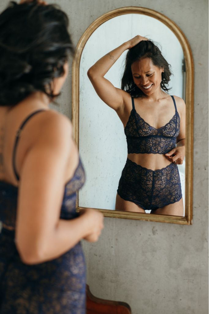 das Model bestaunt ihre Unterwäsche im Spiegel