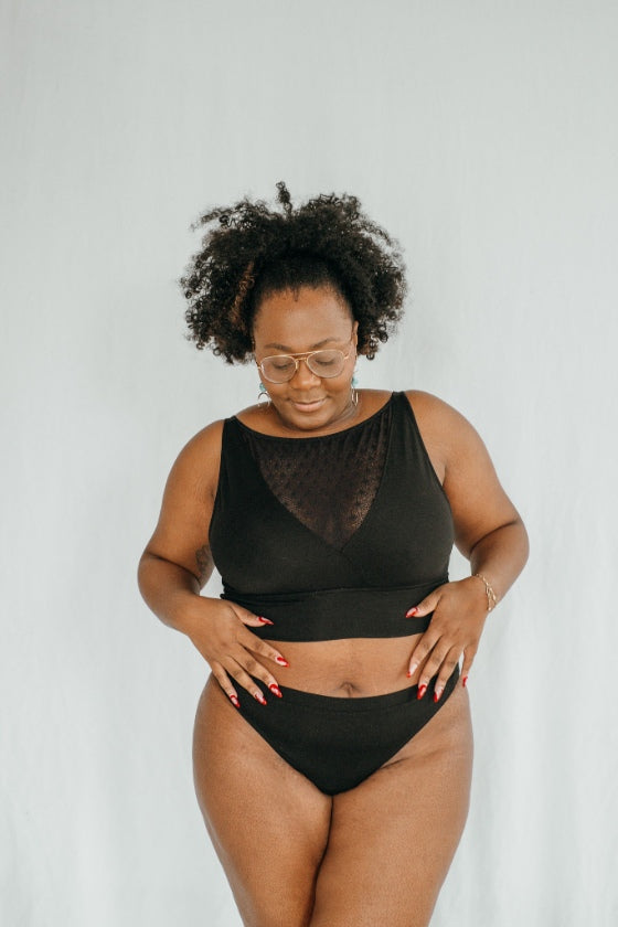 la femme porte le Leila Bralette  avec un décolleté profond en dentelle