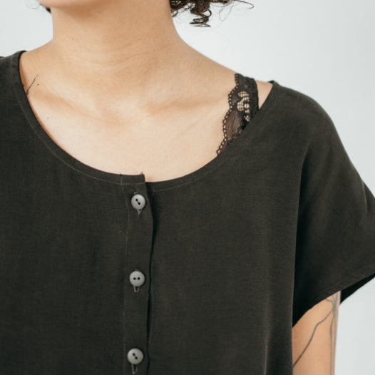 Le modèle porte un chemisier en cupro doux comme de la soie.