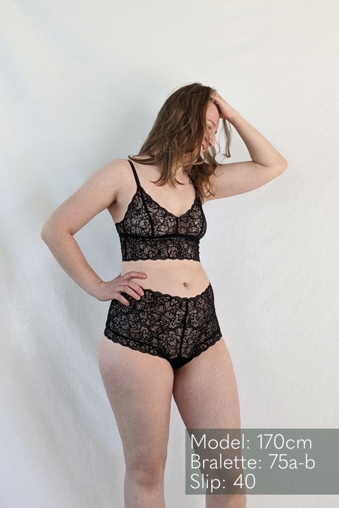 the woman shows herself in Joy panties and Joy Bralette  in black and looks to the side