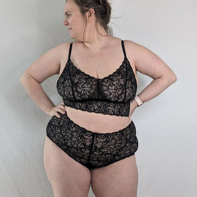 The woman poses in a large size the beautiful lacy underwear