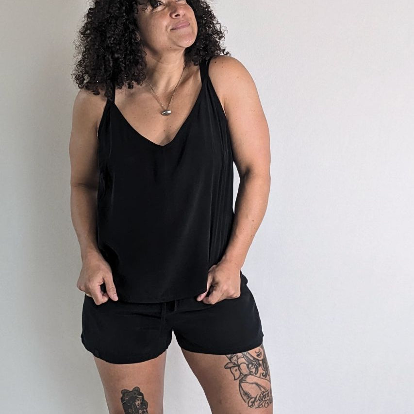 the model poses in a Kat top and matching Kat shorts and looks up at the ceiling