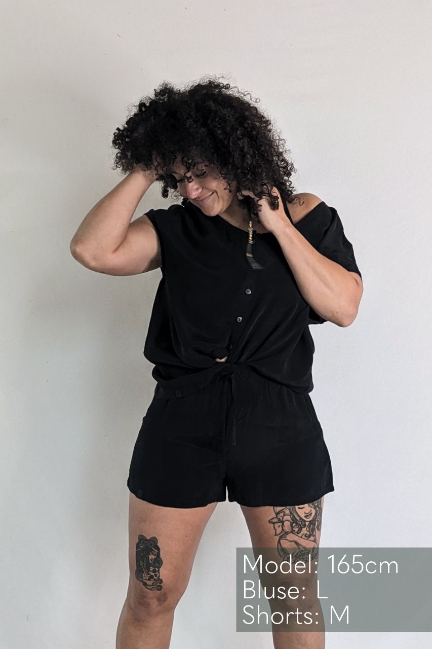 The woman with the frizzy hair wears the Noe top and the Kat shorts made from sustainable materials