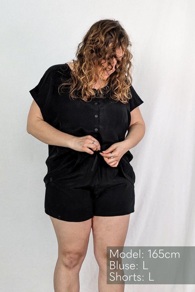 The model is wearing a top and shorts in size L made from soft fabrics in black