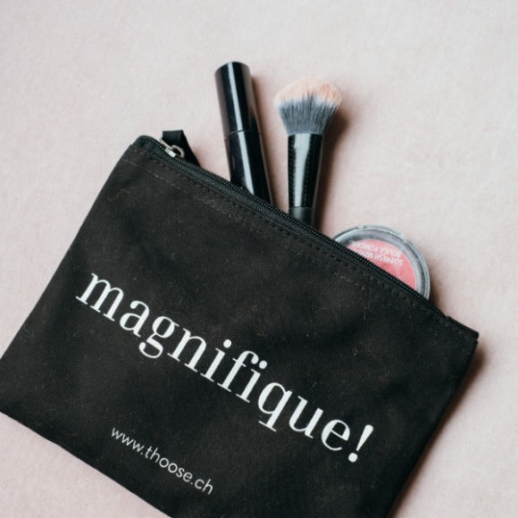 Black cosmetics bag with make-up items