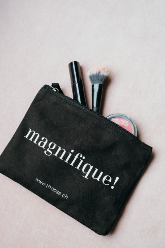 Black cosmetics bag with make-up items