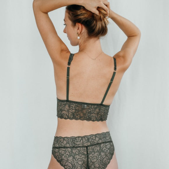 Model wears dark green set of Bralette and slip, photographed from behind.