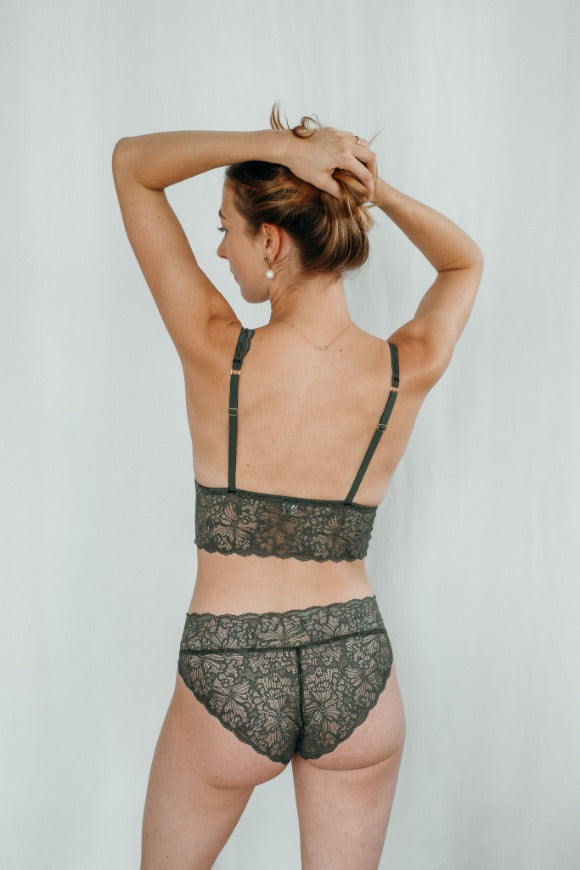 Model wears dark green set of Bralette and slip, photographed from behind.