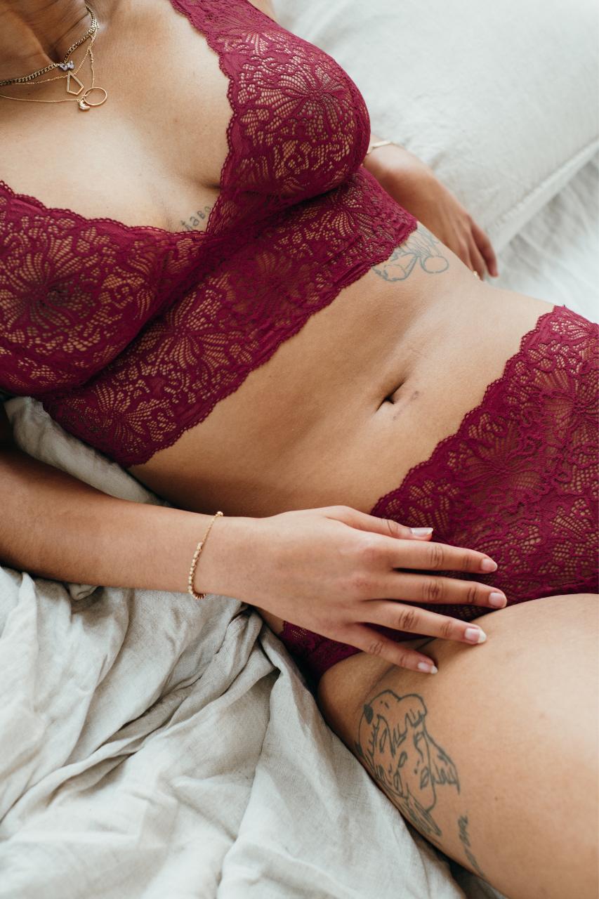 Close-up of Bralette and slip Belle in ruby red with focus on the fine lace.