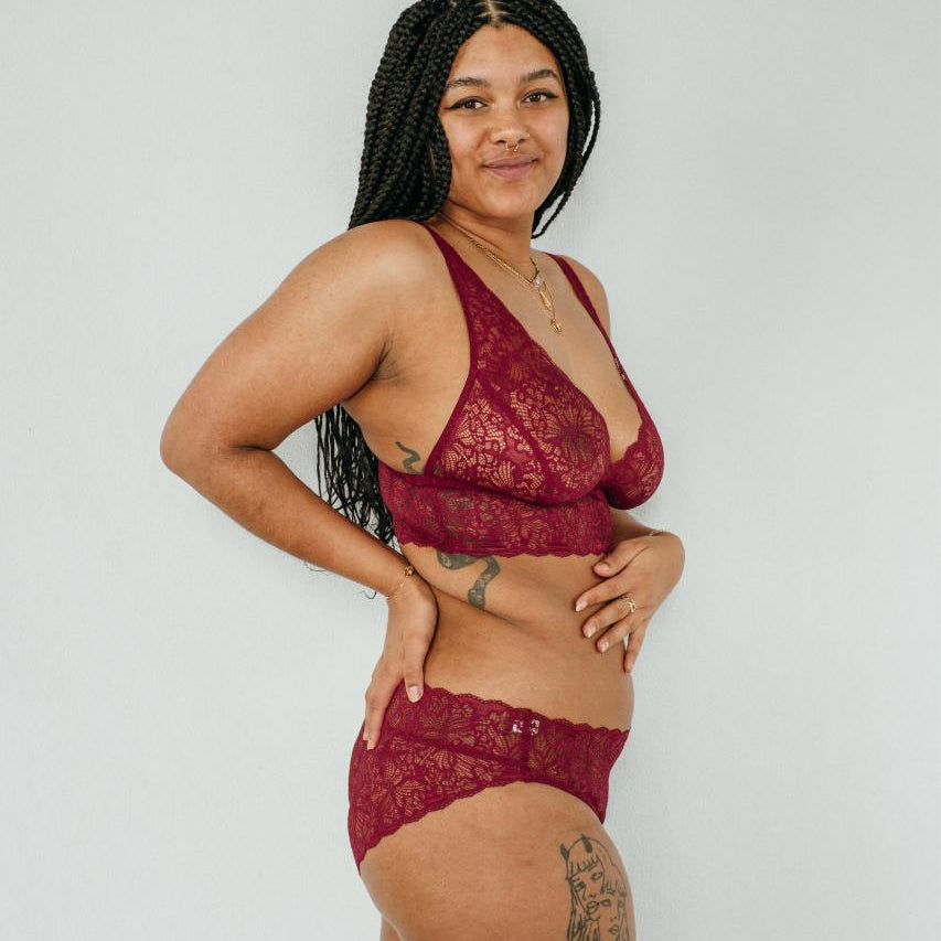 Belle bra and slip in ruby red, photographed on model from the side. 