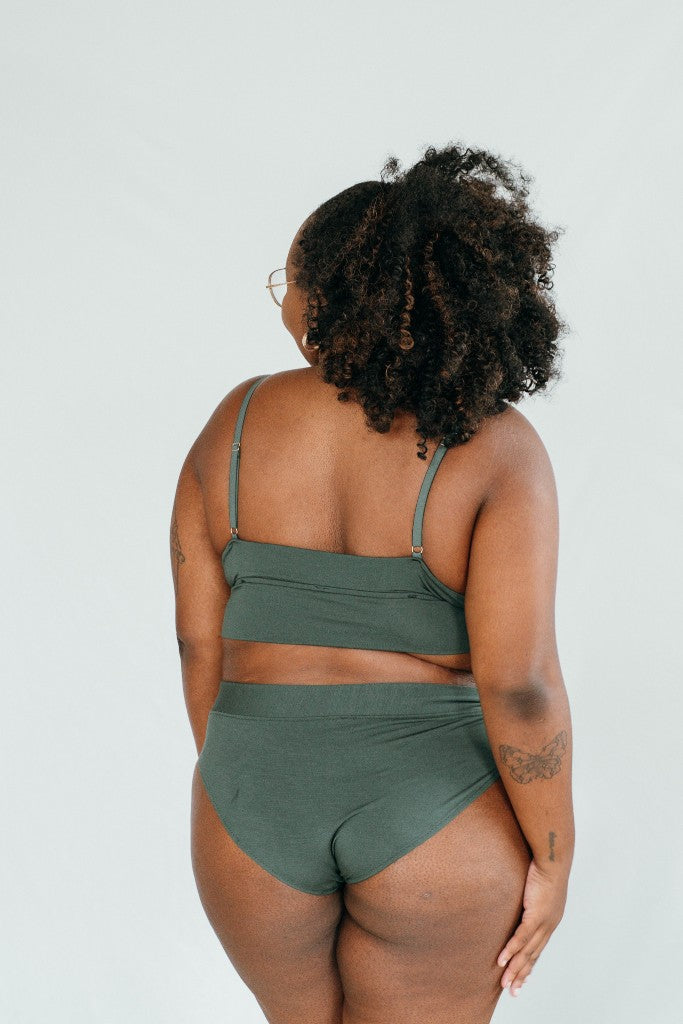 Rear view of dark green set from Bralette and slip "Emma", photographed on model.