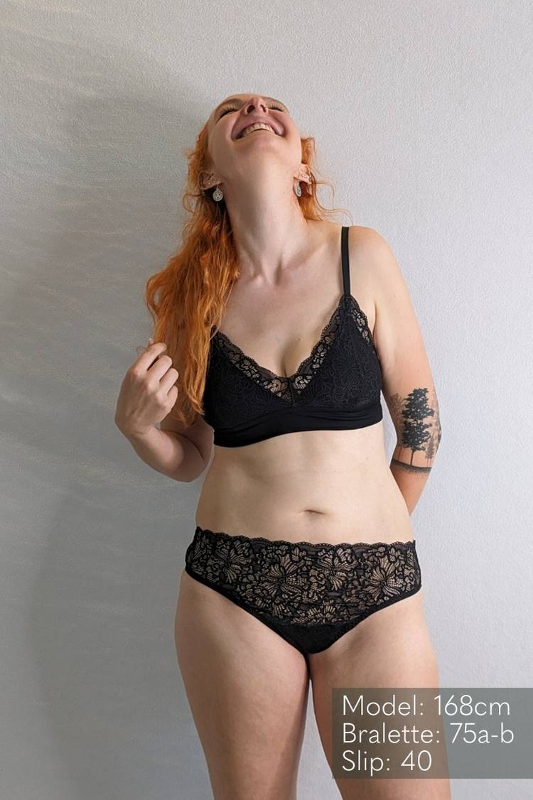 Woman wears Bralette and String Lana in black. 