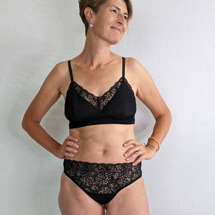 Woman wears fine String made of lace with opaque Bralette