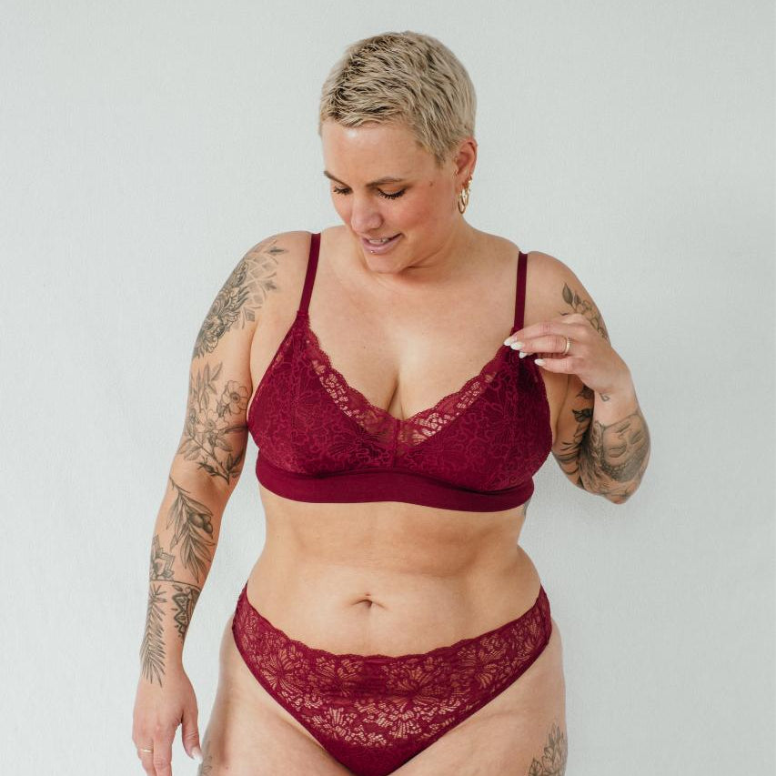 Model presents red lingerie set Lana and shows the fine lace.