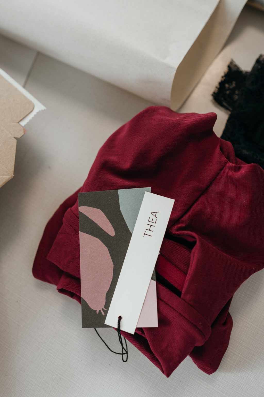 Red bra made from sustainable Tencel Lyocell is folded on a gray background. 