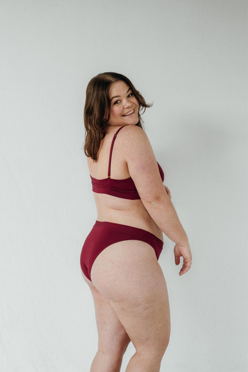 Side view of slip and Thea bra in ruby red.
