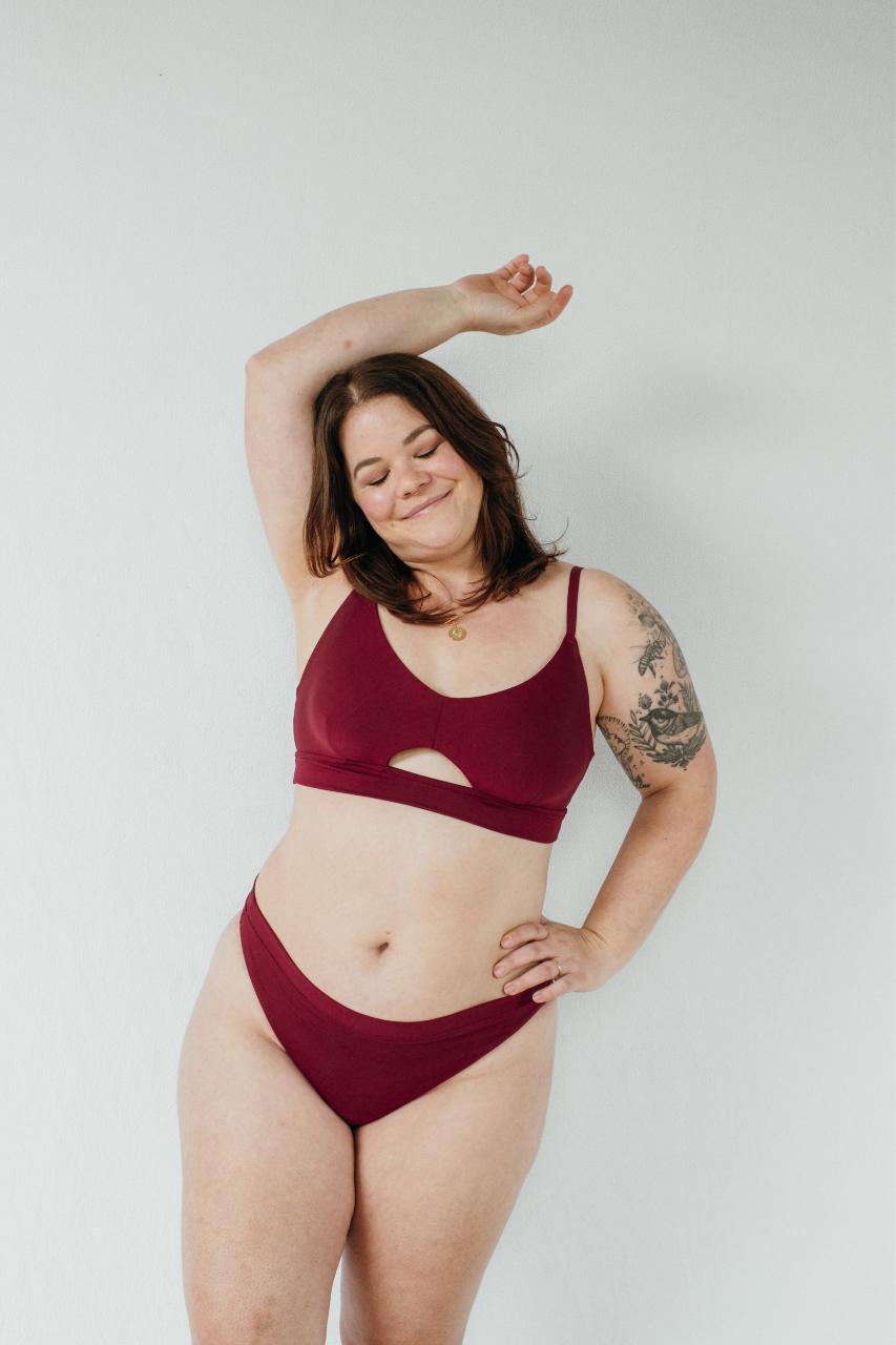 Front view of Thea Bralette with cut-out and matching slip in ruby red.
