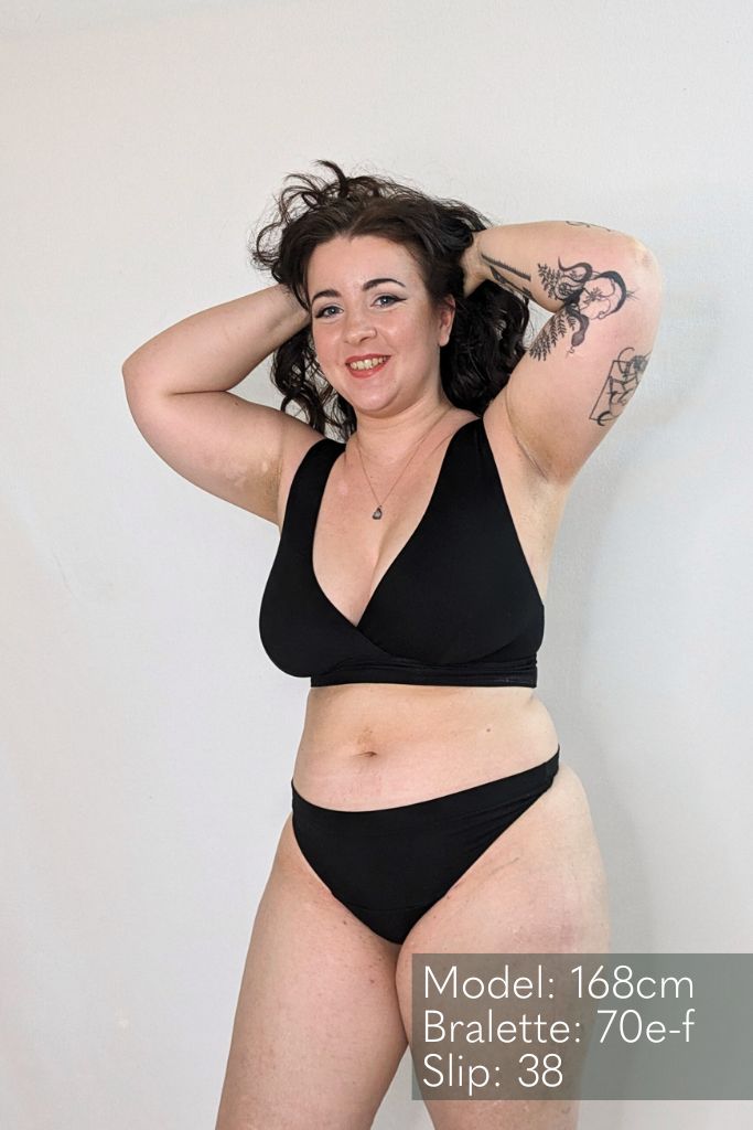 The woman wears black lingerie made of a String and a Bralette made of comfortable and skin-friendly fabric