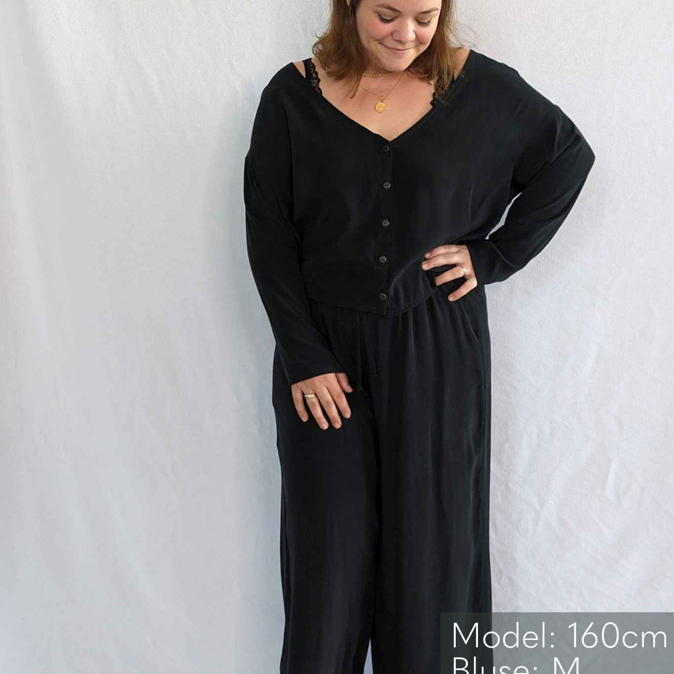 Woman smiles shyly in pyjamas from thoughts of september