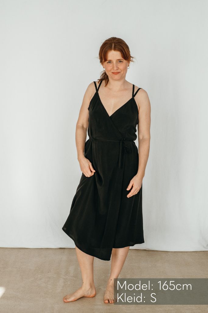 The woman poses in a pretty Zia dress and looks into the camera