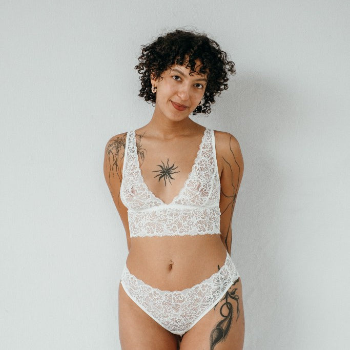the woman in the photo is wearing white underwear consisting of a top and underpants in the color white