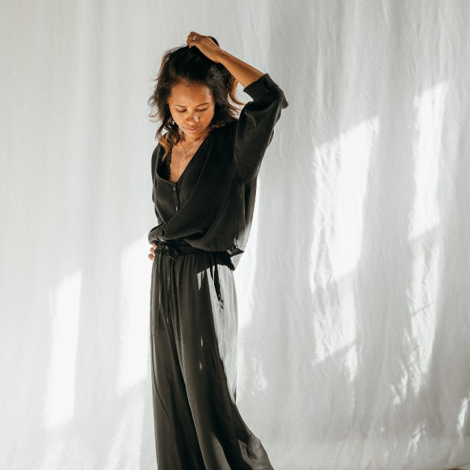 Woman wears wide-cut culottes and the Coco blouse in black