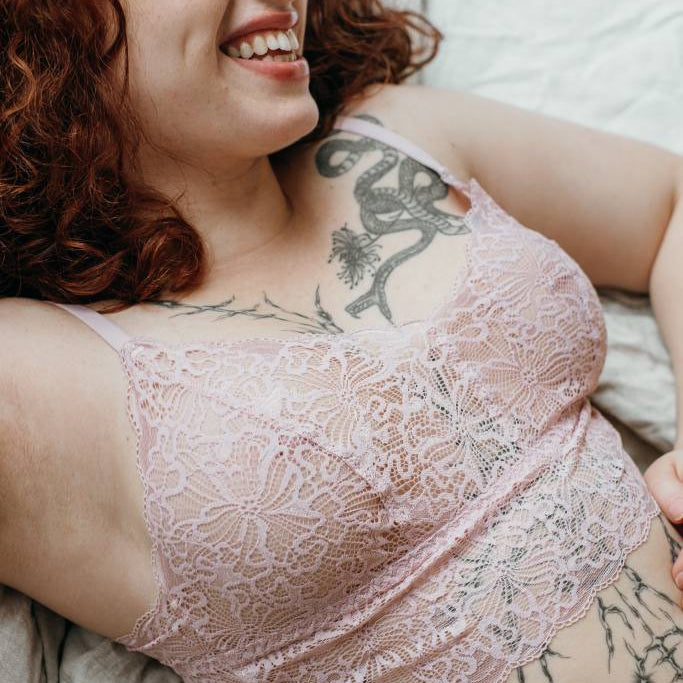 The smiling woman with the red hair appears in the Joy set of Bralette and slip