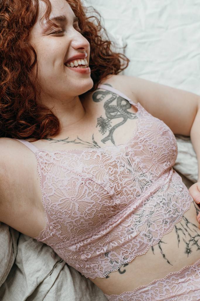 The smiling woman with the red hair appears in the Joy set of Bralette and slip