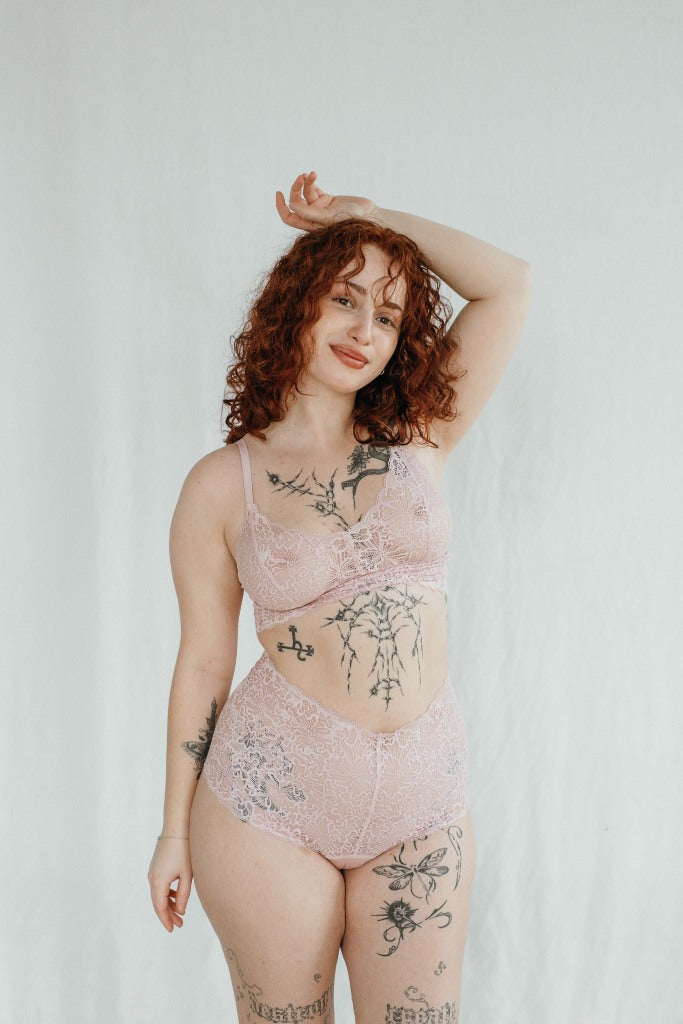 The pretty model appears in the lace set Joy in the color dahlia rose