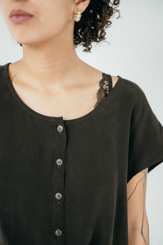 The model is wearing a blouse made from silky soft cupro