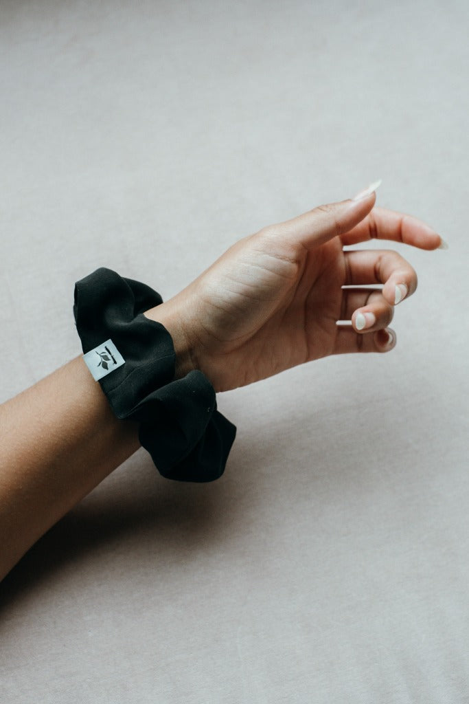 Scrunche, made from leftover material, presented on the wrist.