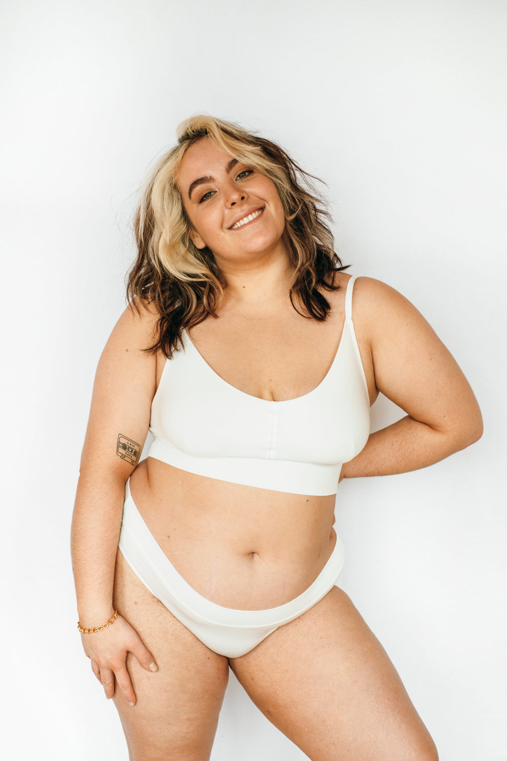 Person with big size wears white underwear made of TENCEL™.