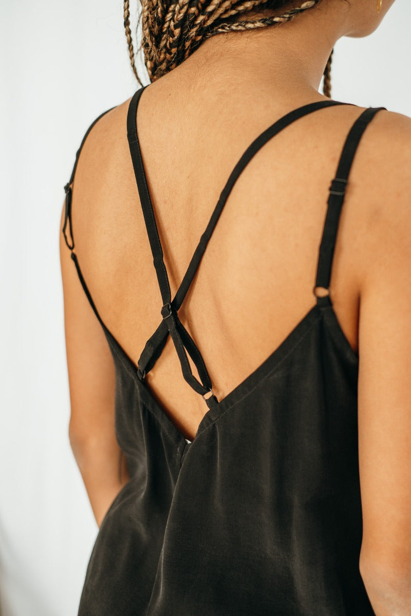 Detail view of the back neckline of the black cupro top.