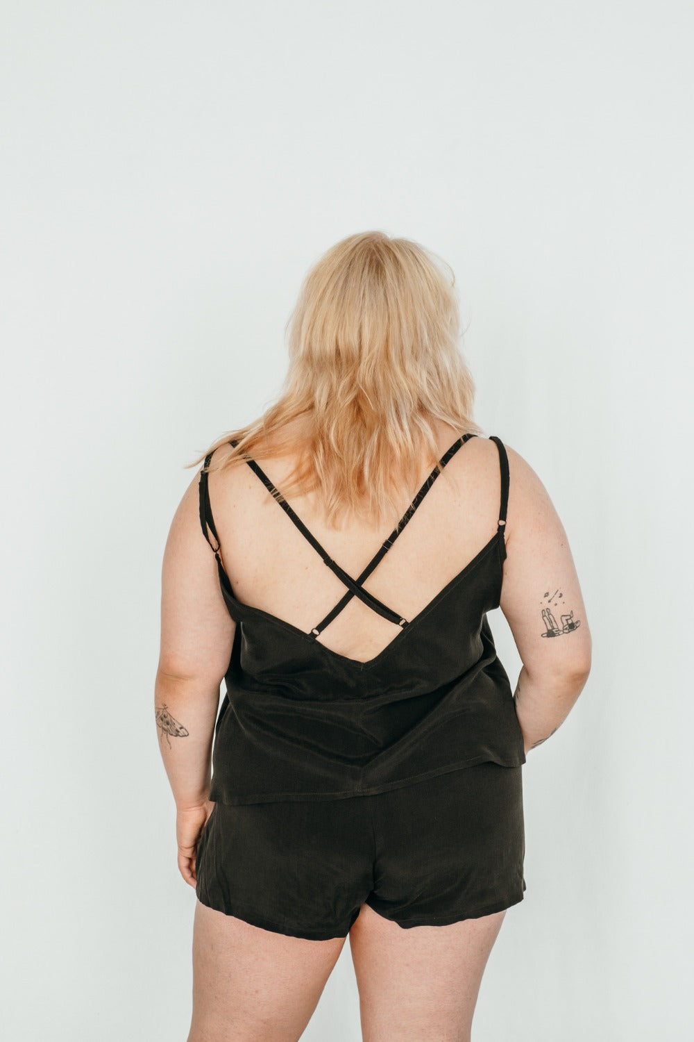Plus size model wears top with big back neckline and short shorts