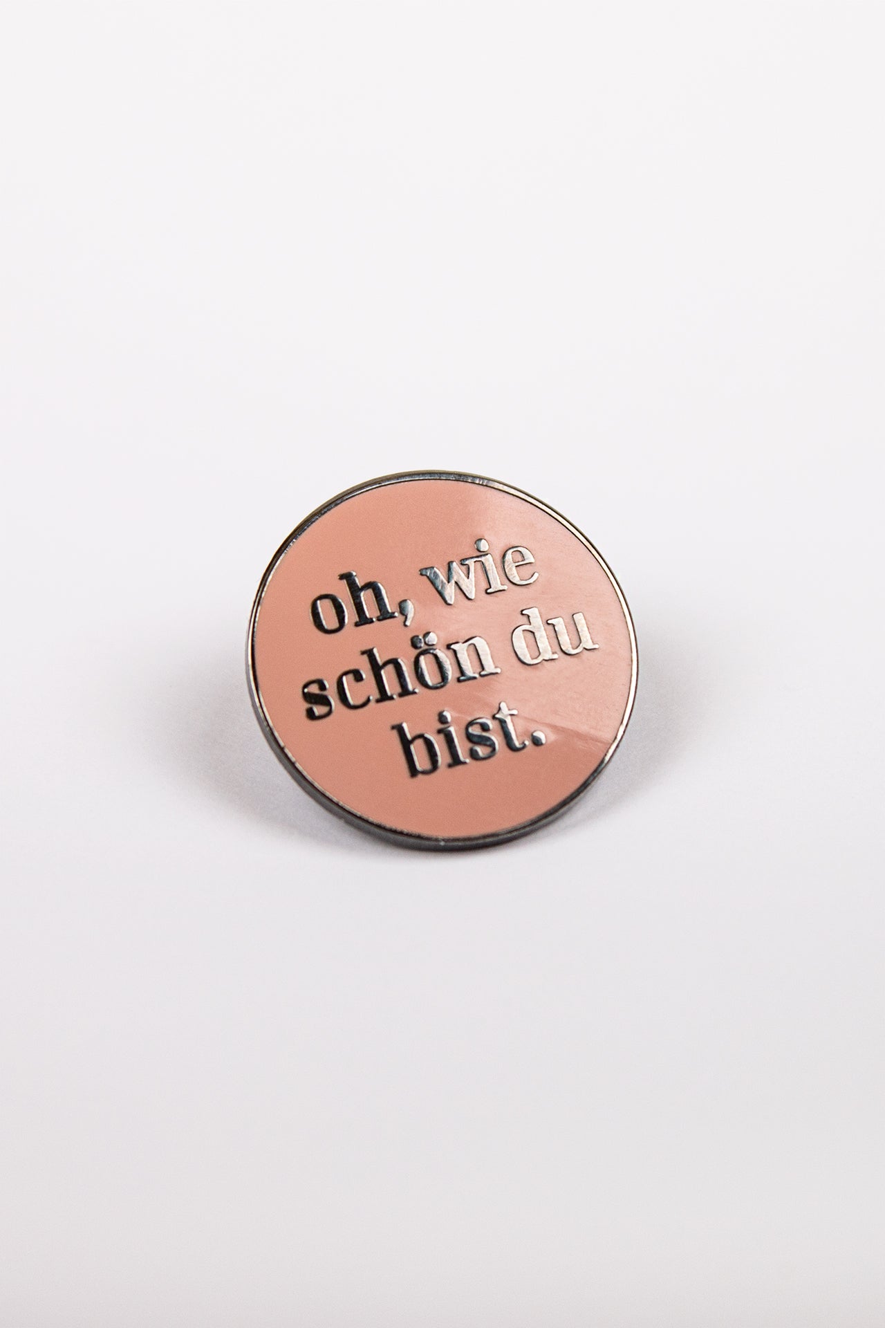 Pin with writing "Oh, how beautiful you are!" in rose